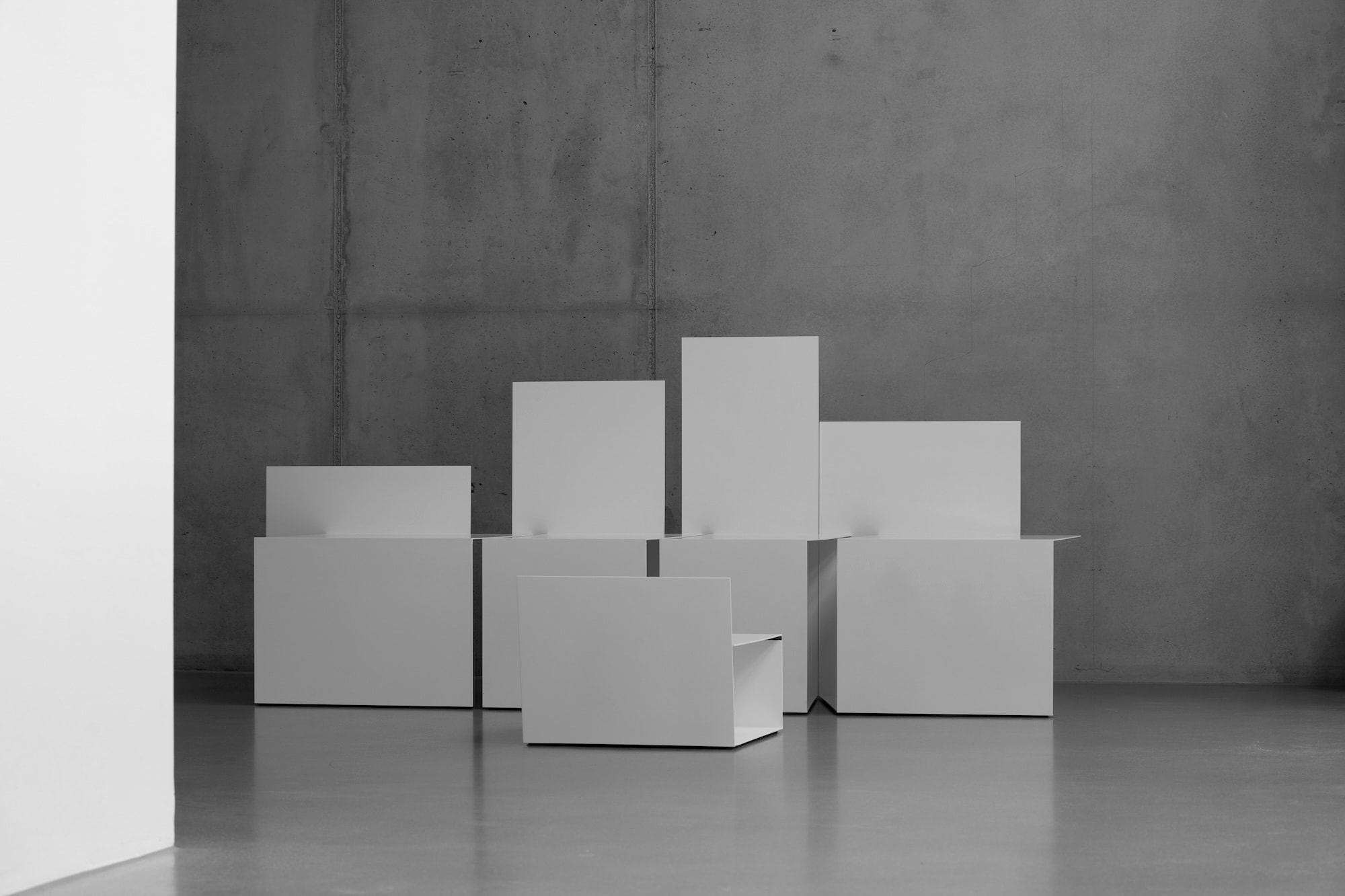TRO chairs in front of a concrete wall